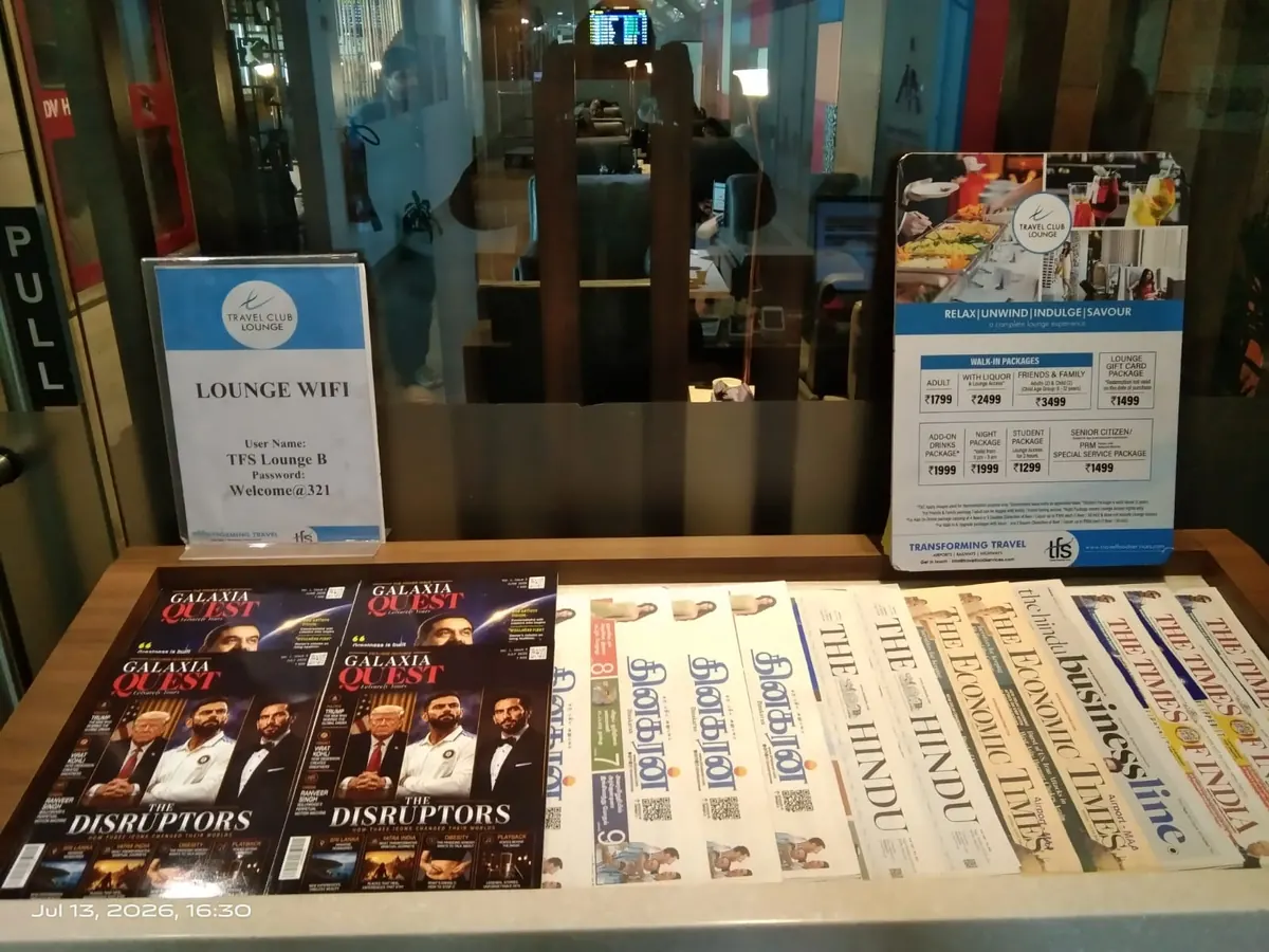 Copies of Galaxia Quest on a rack in an airport travel lounge, alongside The Hindu, The Economic Times and The Times of India.